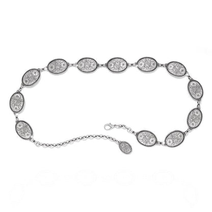 Brighton chain belt with oval silver-tone engraved floral concho links and lobster clasp closure on a white background