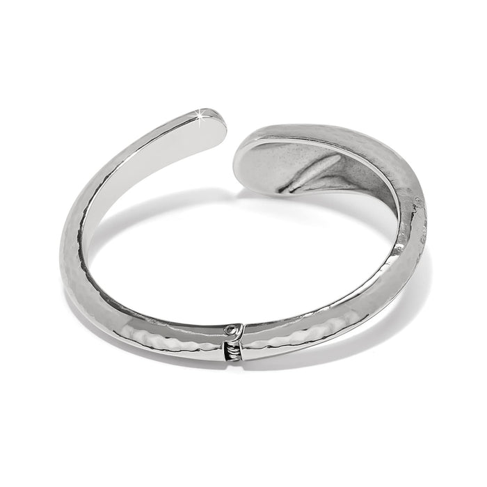 Brighton hinged bangle bracelet with hammered silver-plated finish and open bypass design on a white background