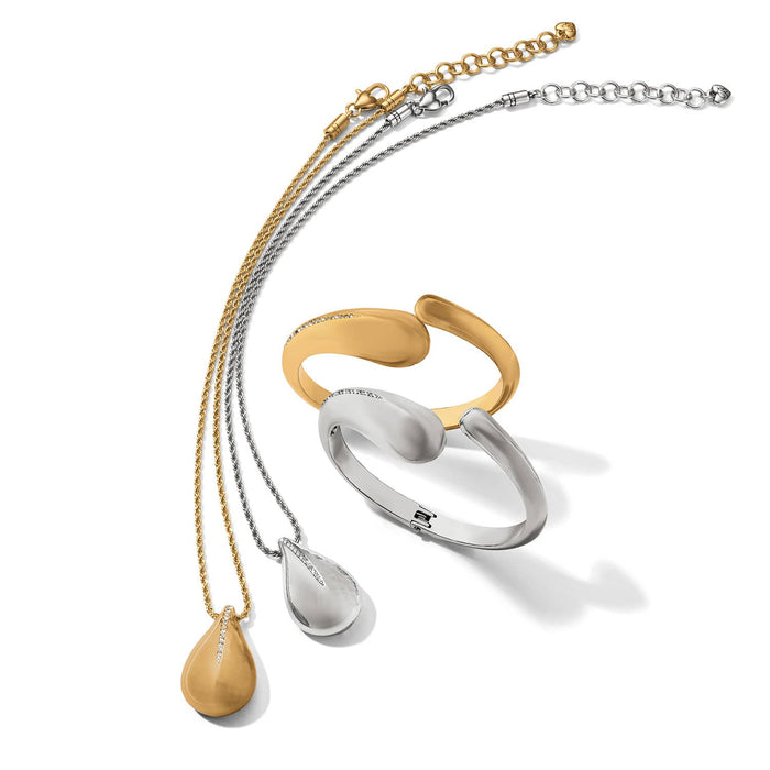 Brighton gold and silver teardrop pendant necklaces with crystal accents and matching hinged bangles on a white background