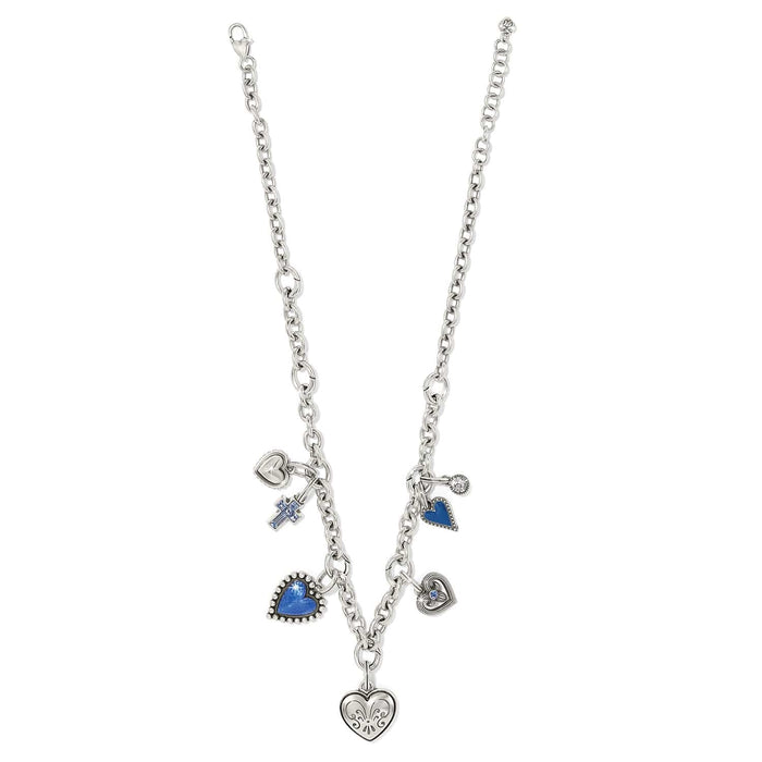 Brighton silver-plated charm necklace with blue enamel hearts, crystal cross, and engraved heart pendant on a white background