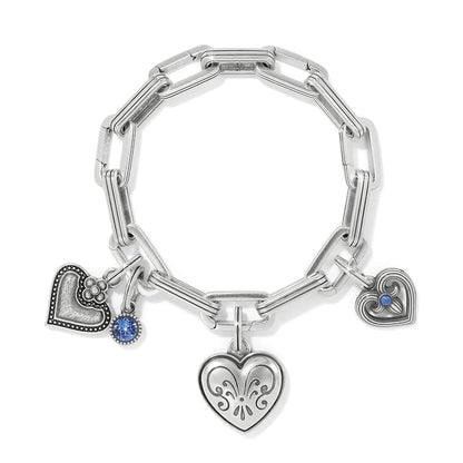 Brighton silver-plated charm bracelet with heart charms, blue crystal accent, and paperclip chain links on a white background