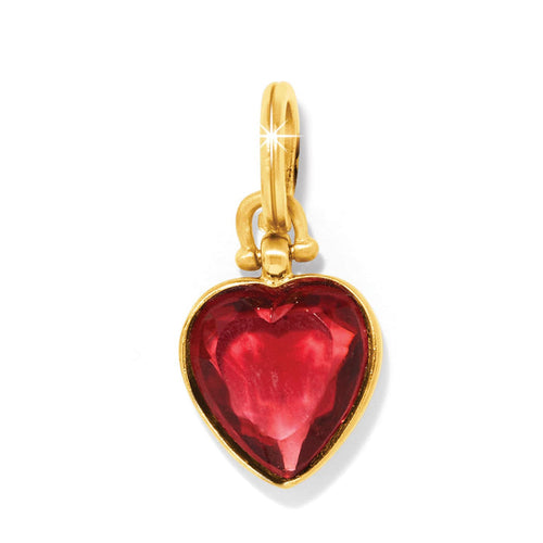 Brighton heart charm with red faceted stone and gold-plated bezel setting on a white background