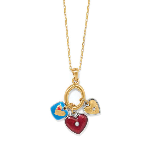 Brighton charm necklace with red enamel heart, blue enamel charm, and gold-tone heart pendant on a white background