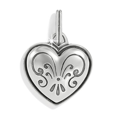 Brighton heart charm with silver-plated finish and embossed scroll fleur design with hinged bail on a white background
