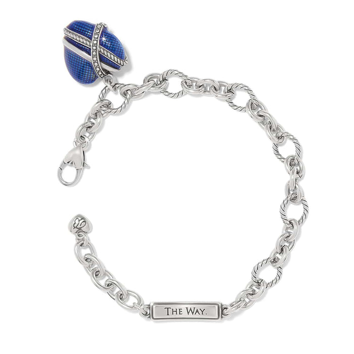 Brighton charm bracelet with blue enamel egg charm, crystal accents, silver-plated chain links, and engraved tag on a white background