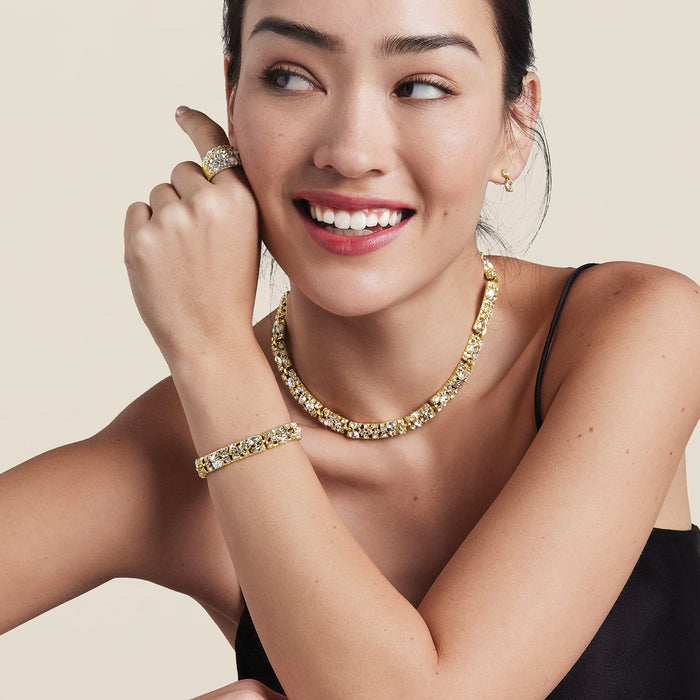 Model wearing a Brighton gold-plated crystal necklace with coordinating Brighton accessories including bracelet, ring, and earrings