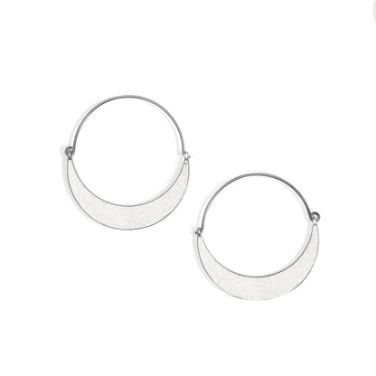 Brighton hoop earrings with silver-tone crescent shapes and hammered finish on thin wire hoops on a white background