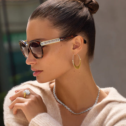 Model wearing Brighton tortoise sunglasses with gold and silver filigree temples and coordinating Brighton accessories