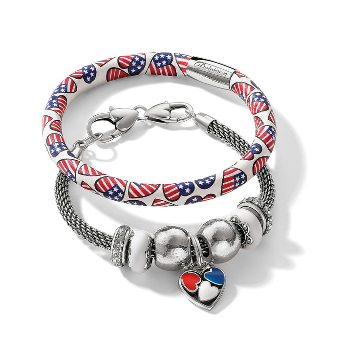 Brighton bracelets with American flag heart print leather band and silver-plated mesh charm bracelet on a white background