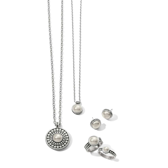 Brighton silver-plated jewelry set styled with glass pearl cabochon necklaces, stud earrings, and rings on white background