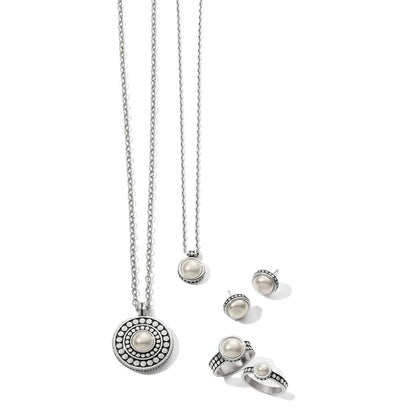 Brighton silver-plated jewelry set styled with glass pearl cabochon necklaces, stud earrings, and rings on white background