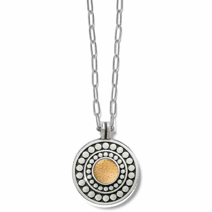 Brighton pendant necklace with two-tone circular medallion, silver dot patterns, and gold center on a white background