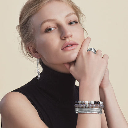 Model wearing Brighton silver-plated ring, beaded bracelets, cuff, and drop earrings with pearl and gray beads