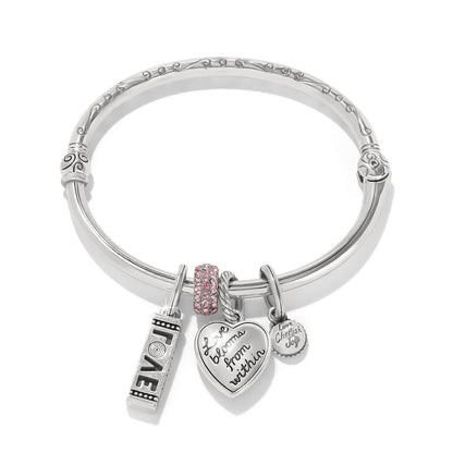 Brighton silver-plated bangle bracelet with pink crystal bead and engraved heart love charms on a white background