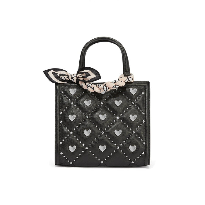 Brighton black quilted handbag with silver-tone heart studs and patterned scarf tied around handle on a white background