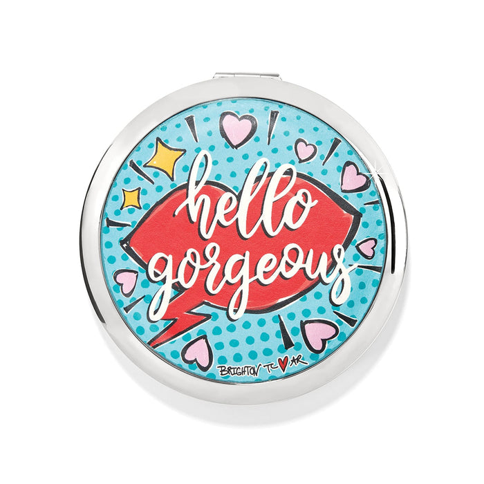 Brighton compact mirror with pop-art print featuring red lips, hearts, and hello gorgeous text on a white background