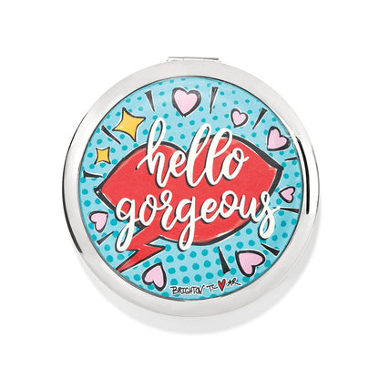Brighton compact mirror with pop-art print featuring red lips, hearts, and hello gorgeous text on a white background