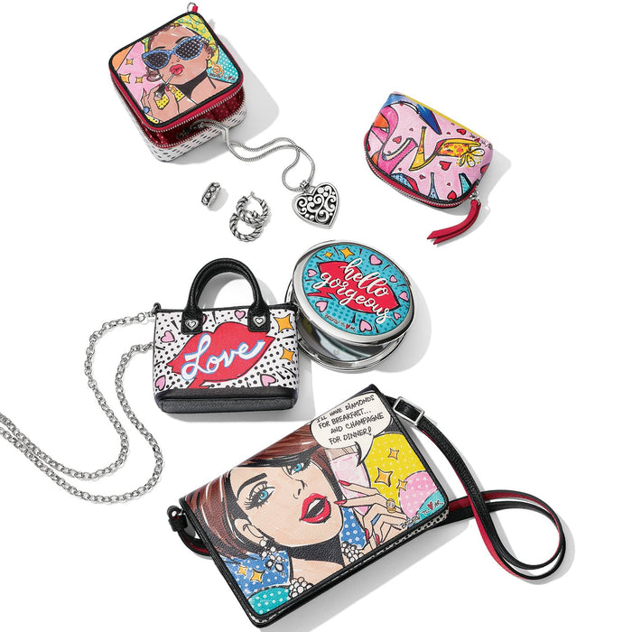 Brighton handbags styled with pop-art print pouches and coordinating jewelry accessories on a white background