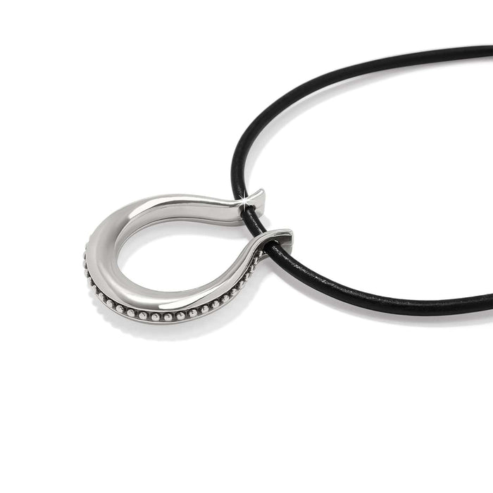 Close-up of Brighton pendant necklace with silver-plated horseshoe loop, beaded edge detail, and black leather cord