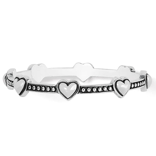 Brighton bangle bracelet with silver-plated raised heart motifs and beaded band detailing on a white background