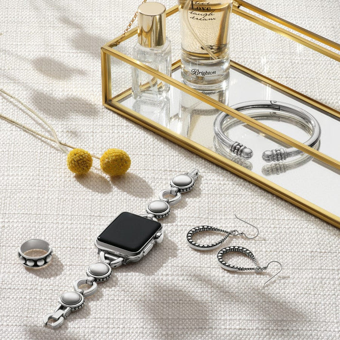 Pretty Tough Bold Watch Band on Apple Watch with matching jewelry and perfume placed on a textured surface near a mirrored tray. A watch, rings, and earrings are visible.