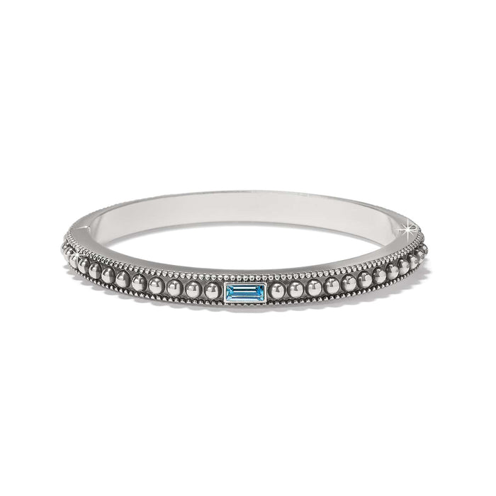 Brighton bangle bracelet with silver-plated beaded design and blue baguette crystal accent on a white background