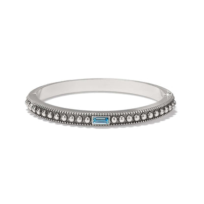 Brighton bangle bracelet with silver-plated beaded design and blue baguette crystal accent on a white background