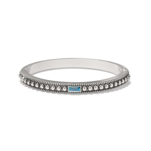 Brighton bangle bracelet with silver-plated beaded design and blue baguette crystal accent on a white background