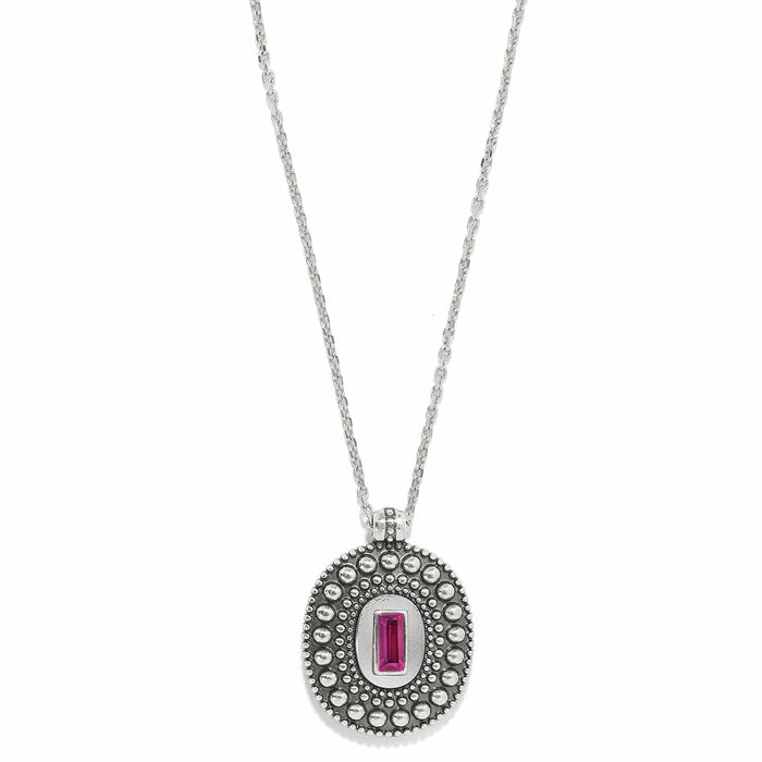 Brighton pendant necklace with silver-plated beaded oval medallion and pink crystal baguette center stone on a white background