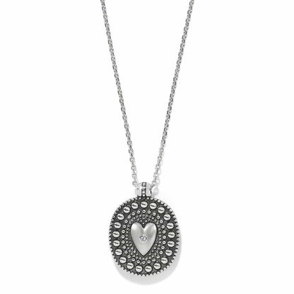 Brighton pendant necklace with silver-plated beaded oval, raised heart, and crystal accent on a white background