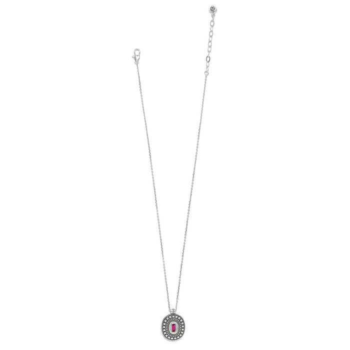 Brighton pendant necklace with silver-plated oval medallion, beaded border, and pink crystal baguette center on a white background