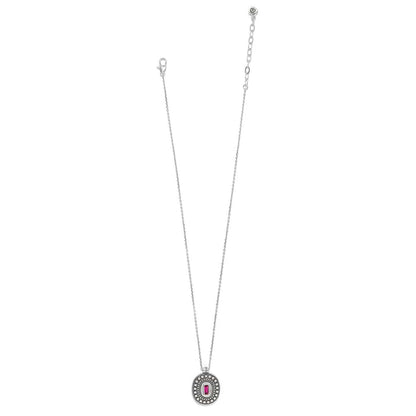 Brighton pendant necklace with silver-plated oval medallion, beaded border, and pink crystal baguette center on a white background
