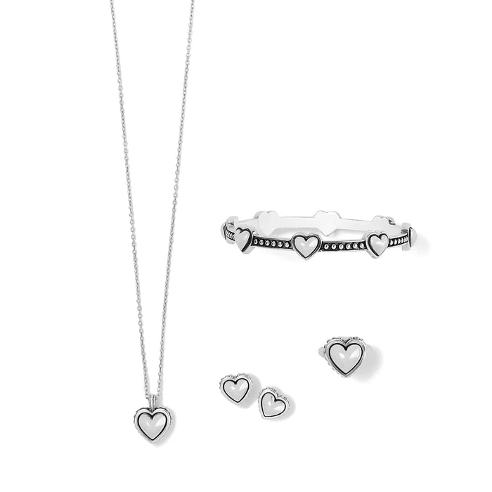 Brighton heart pendant necklace, hinged bangle bracelet, and stud earrings set with silver-plated finish on a white background