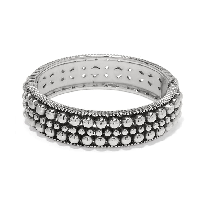Brighton hinged bangle bracelet with three rows of silver-plated beads and ribbed edges on a white background