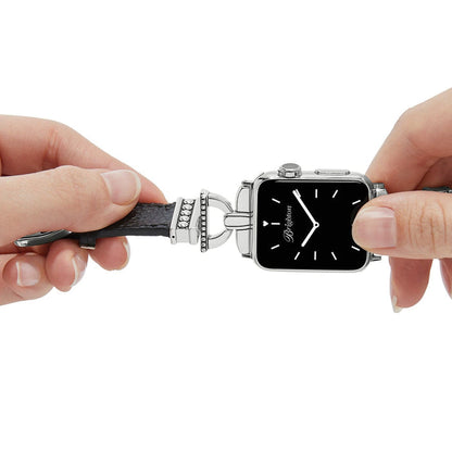 Model attaching a Brighton black leather watch band with silver-plated beaded accents to a square smartwatch