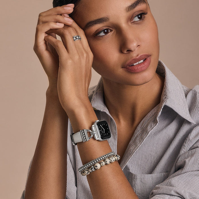 Model wearing a Brighton watch with white leather strap and silver-plated case, styled with coordinating Brighton accessories