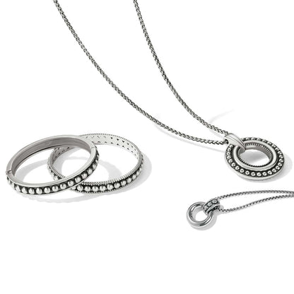 Brighton silver-plated jewelry set styled with beaded bangles and circle pendant necklaces on a white background