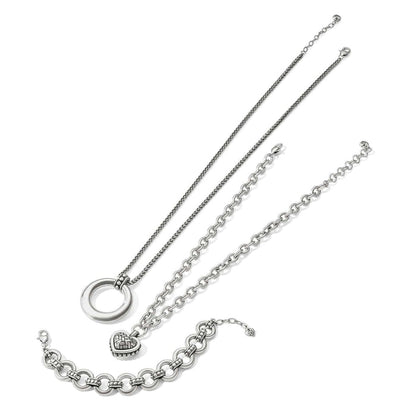 Brighton jewelry set styled with silver-plated pendant necklace and two link bracelets on a white background