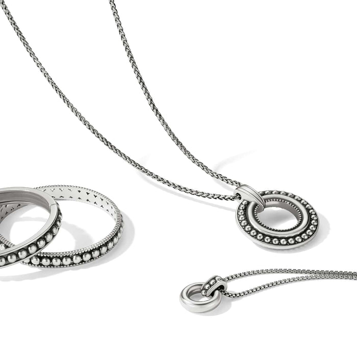 Brighton silver-plated pendant necklace styled with a beaded ring bracelet on a white background