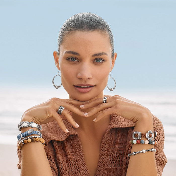 Model wearing Brighton silver-plated hoop earrings with beaded accents and coordinating Brighton bracelets and rings