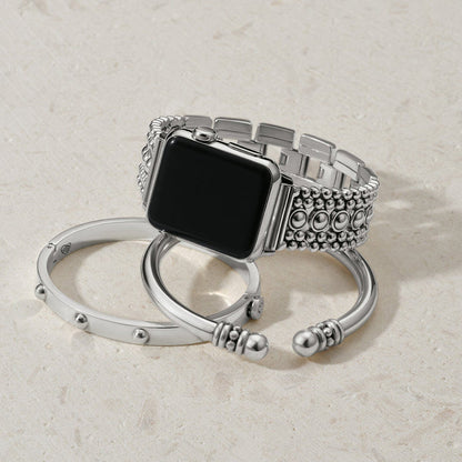 Brighton smartwatch band with silver-plated beaded links, styled with two coordinating cuff bracelets on a neutral background