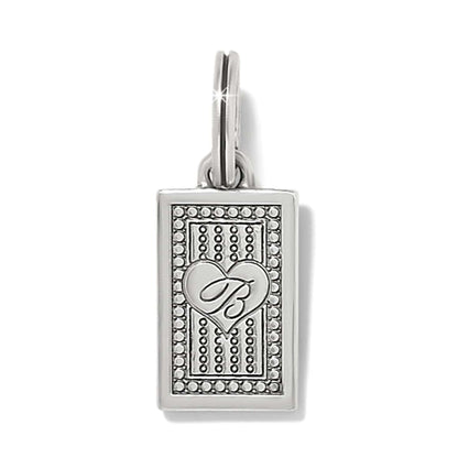 Brighton rectangular charm with silver-plated heart and scripted B emblem over beaded pattern on a white background