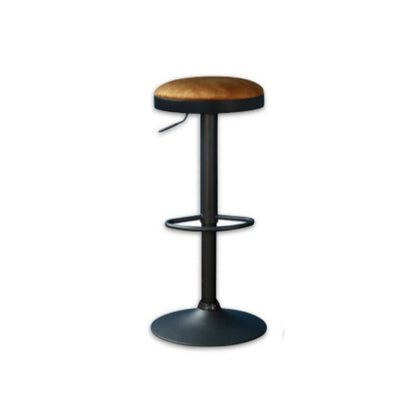 Bar stool with rust coloured upholstered seat and black metal frame on a white background