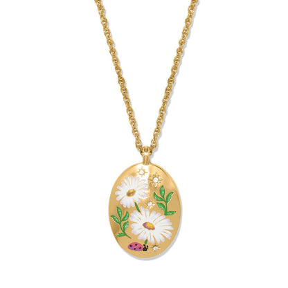 Brighton pendant necklace with gold-plated oval featuring enamel daisies, ladybug, and crystal accents on a white background