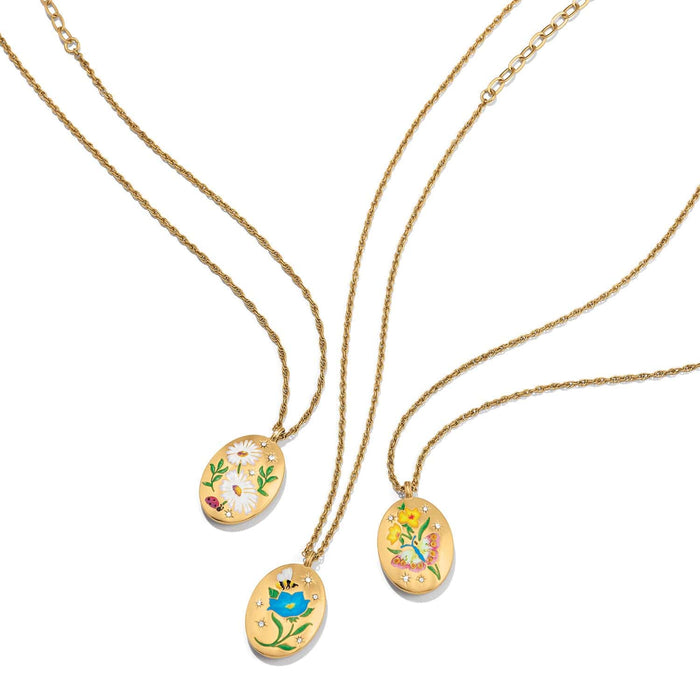 Brighton gold-plated pendant necklaces with enamel floral, butterfly, and daisy designs and crystal accents on a white background