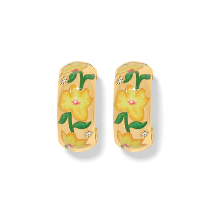 Brighton hoop earrings with gold-plated finish, yellow enamel floral design, and crystal accents on a white background