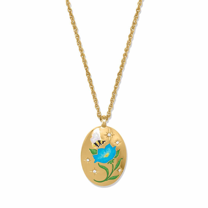 Brighton gold-plated oval pendant necklace with enamel blue flower, bee, and crystal star accents on a white background