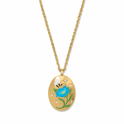 Brighton gold-plated oval pendant necklace with enamel blue flower, bee, and crystal star accents on a white background