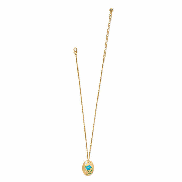 Brighton pendant necklace with gold-plated oval pendant featuring enamel blue flower, bee, and crystal accents on a white background