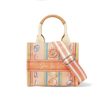 Brighton canvas tote handbag with seashell print, orange stripes, Sea La Vie script, and striped crossbody strap on a white background